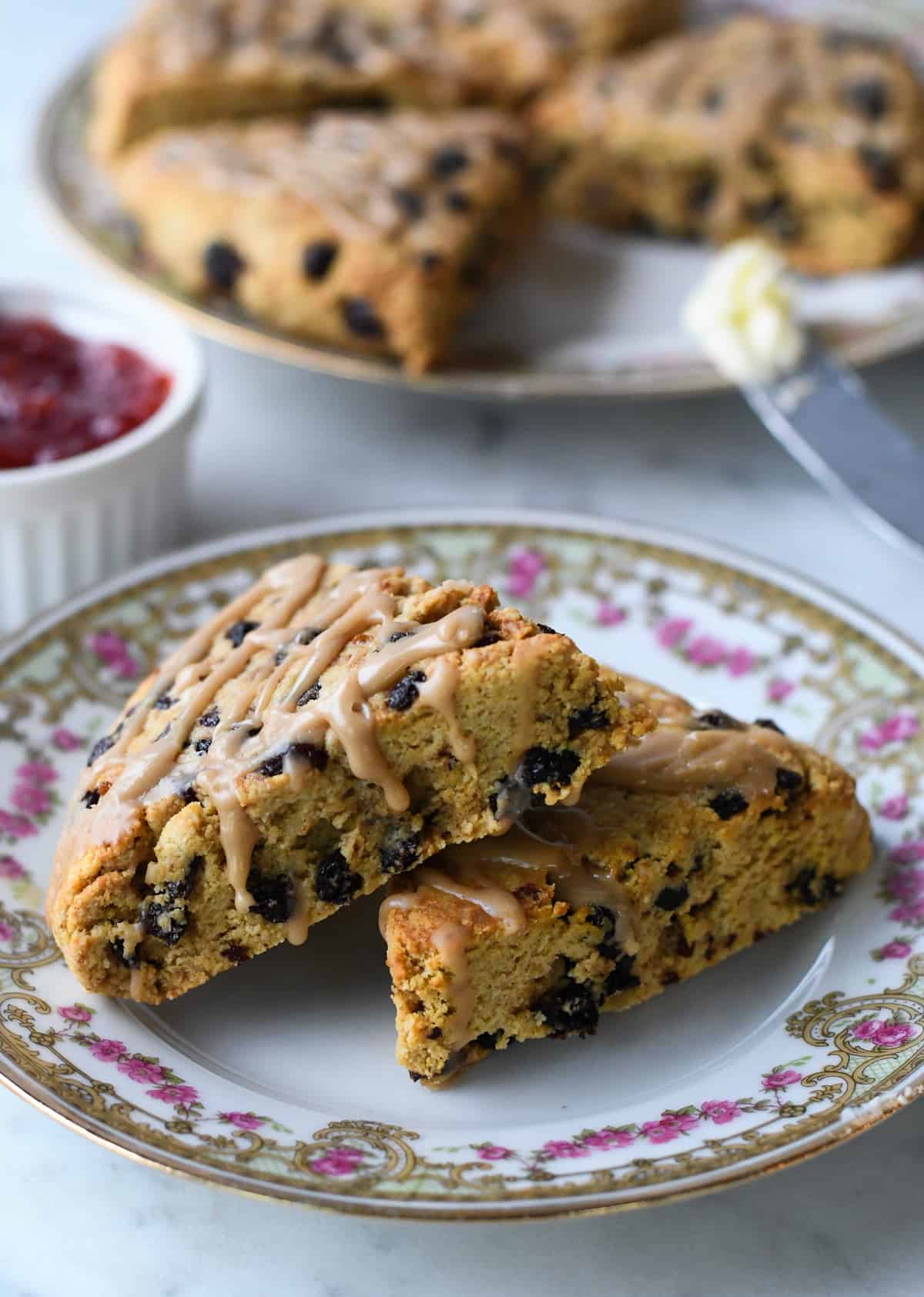 Paleo Currant Scones on plate leaning on one another.