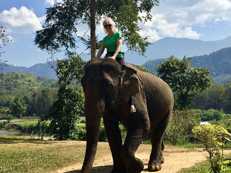 Ingrid riding an elephant
