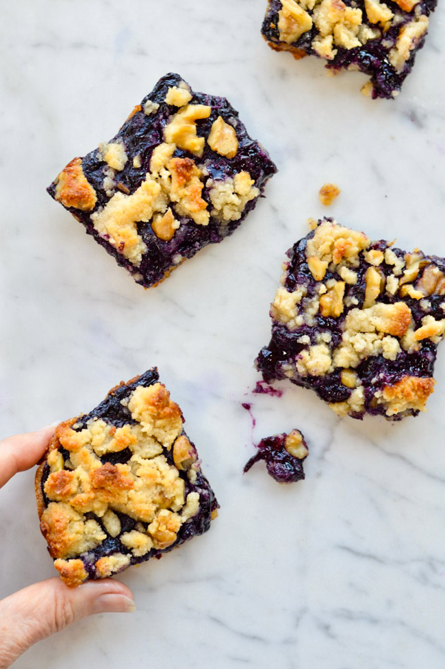 Paleo Blueberry Crumb Bars with hand