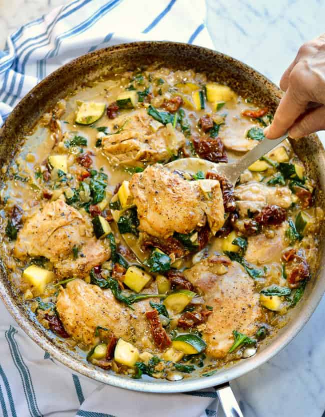 Creamy Italian Chicken and Vegetables pan and hand