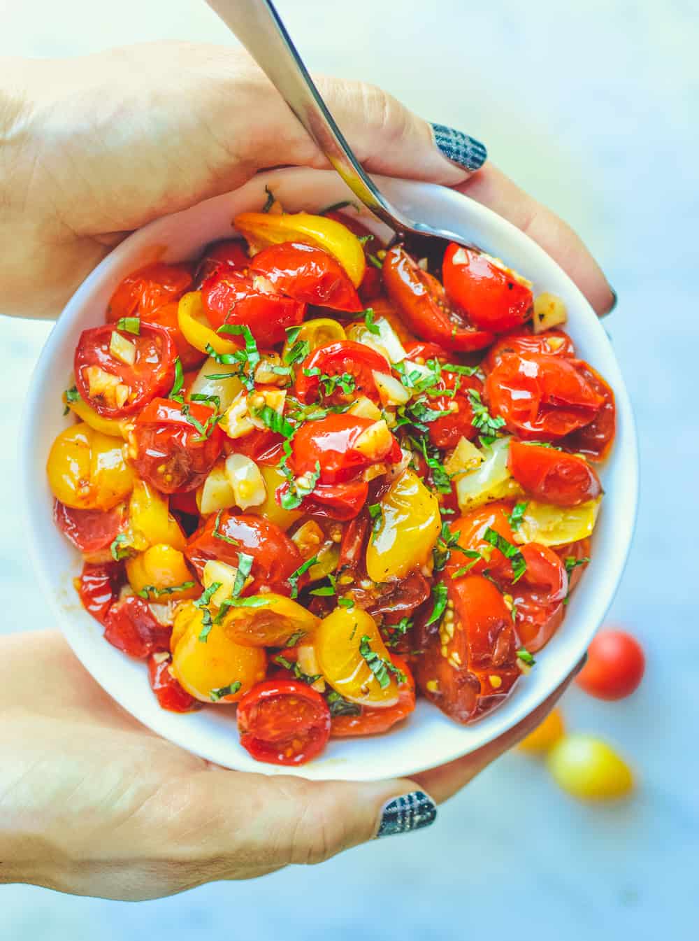 Roasted Jammy Cherry Tomatoes in bowl with hands