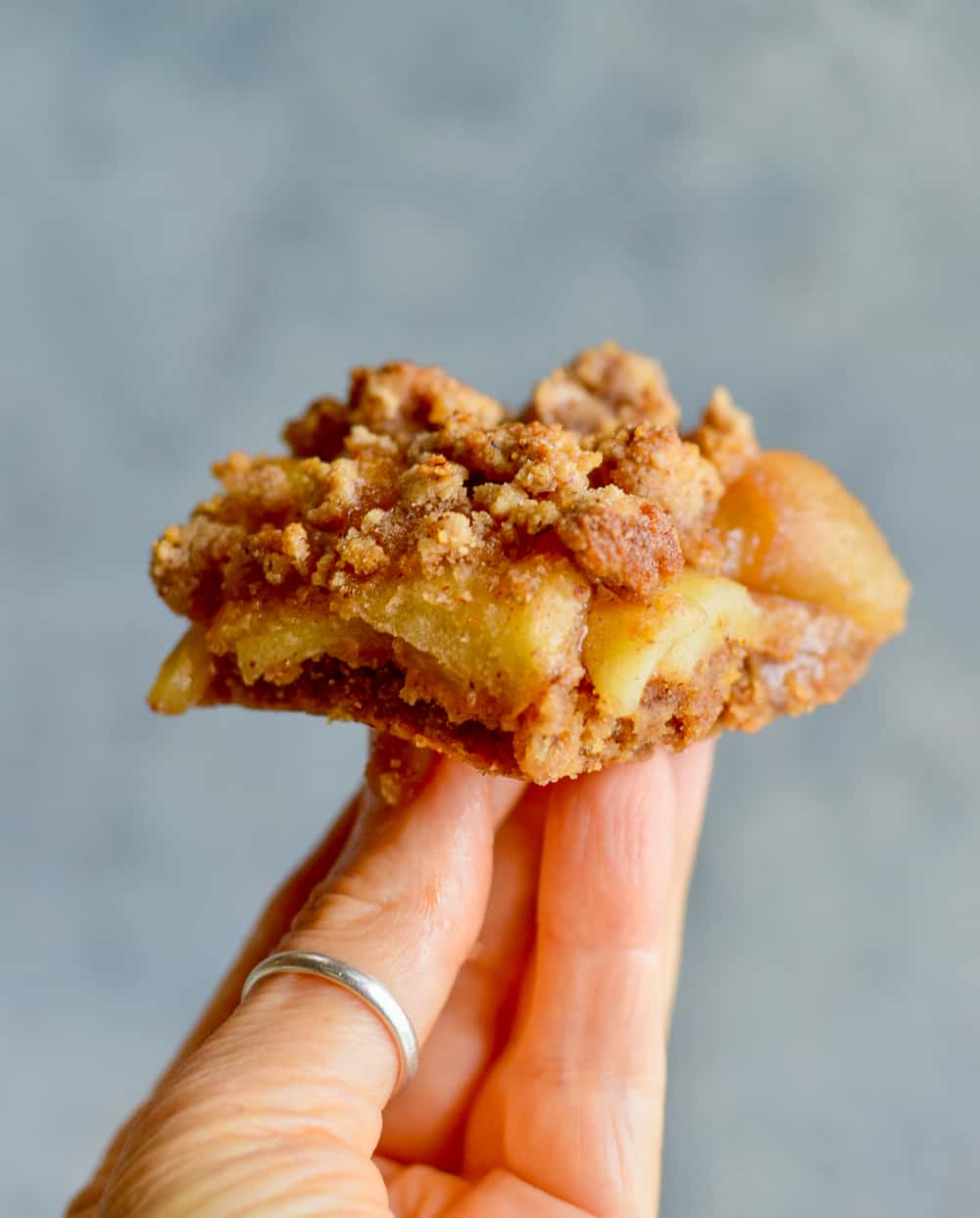 Cookie Crumb Apple Bars perched on hand