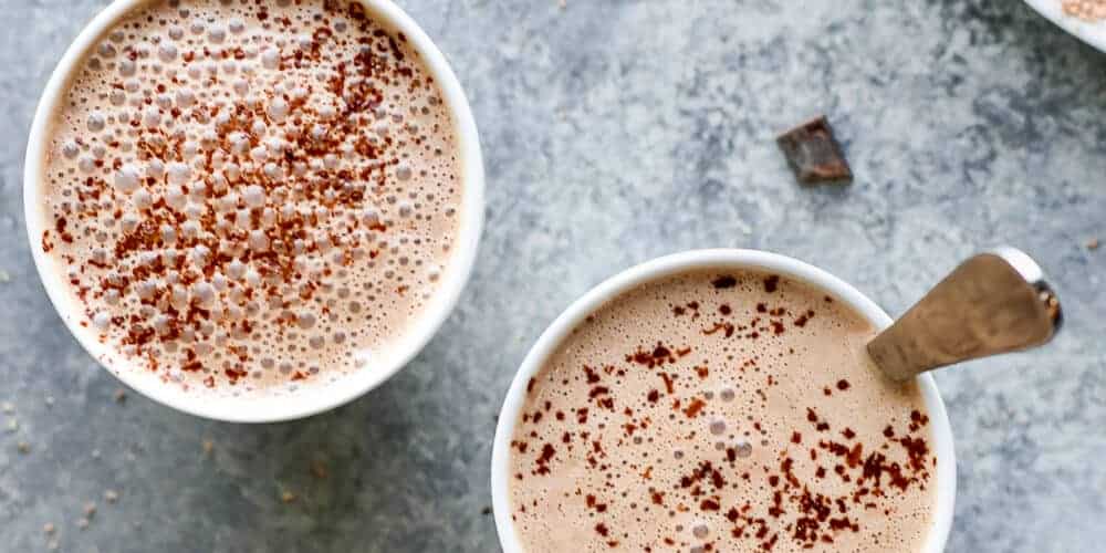 Two hot beverages in mugs.