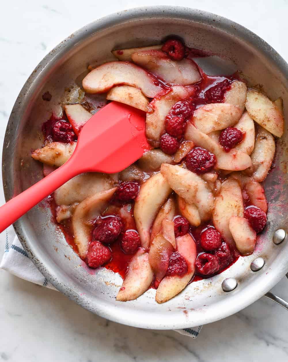 Sauteed Pears with Raspberries and Coconut Yogurt in pan