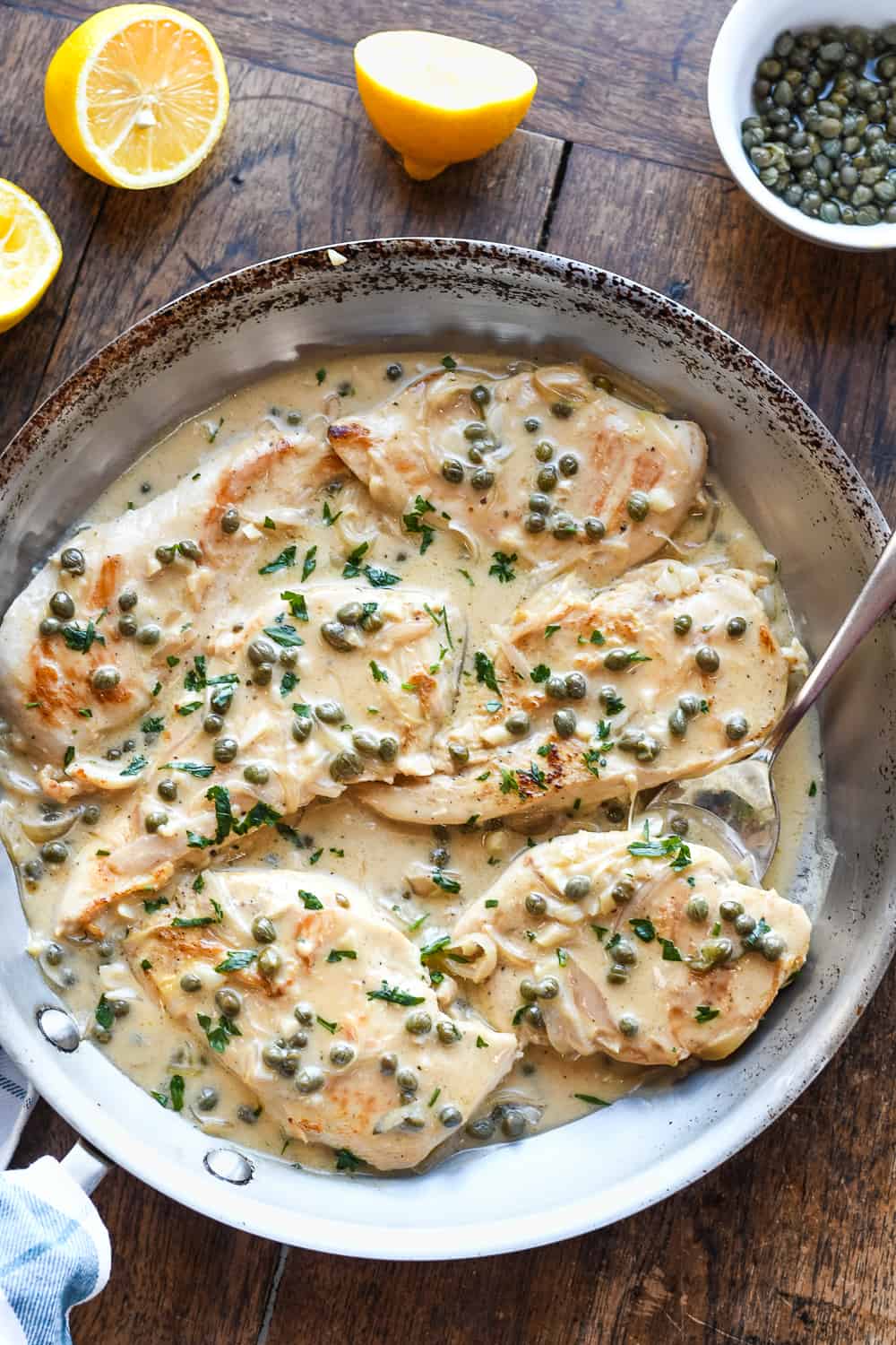 chicken piccata in pan with spoon