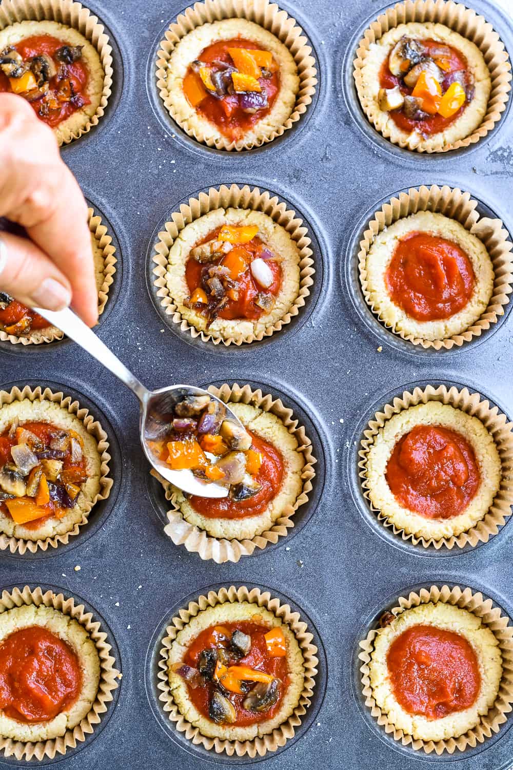 paleo mini pizzas filling with sauce and vegetables