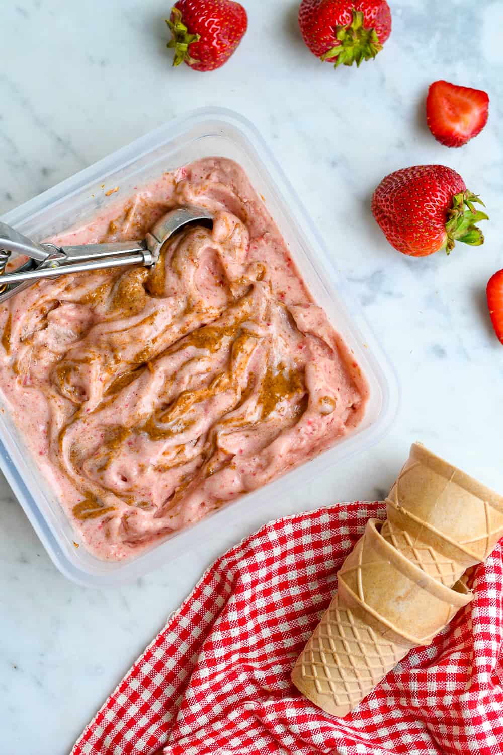 Vegan Strawberry Almond Butter Ice Cream in container with cones