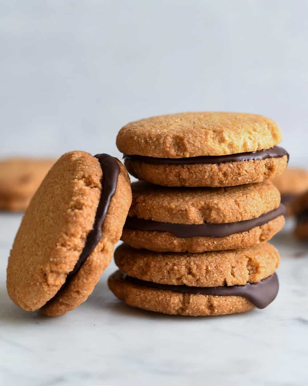 Almond Chocolate Sandwich Cookies leaning cookies