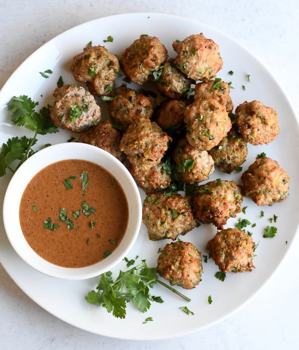 Asian Meatballs with Thai 'Peanut' Sauce on plate with sauce