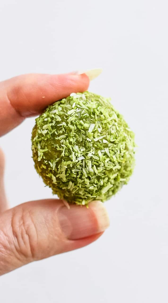 Coconut Matcha Protein Balls hand holding ball