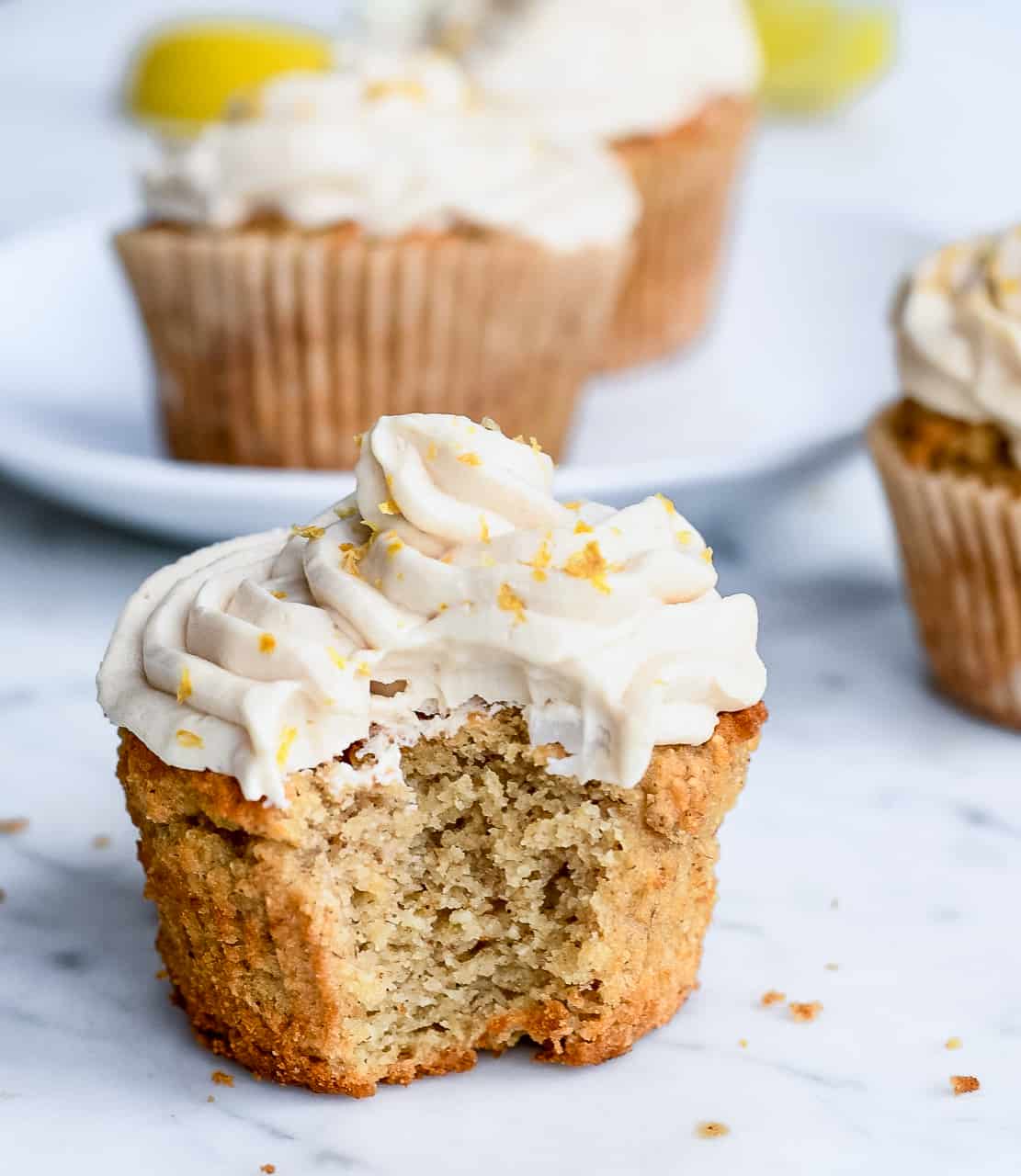 Lemon Cupcakes with Vanilla Frosting with bit close up