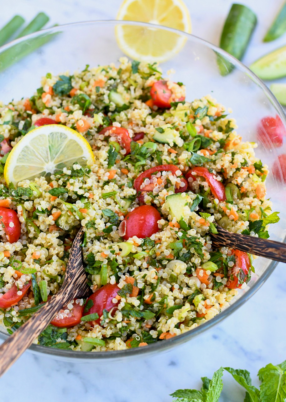 Quinoa Tabbouleh Salad in bowl with serving spoons