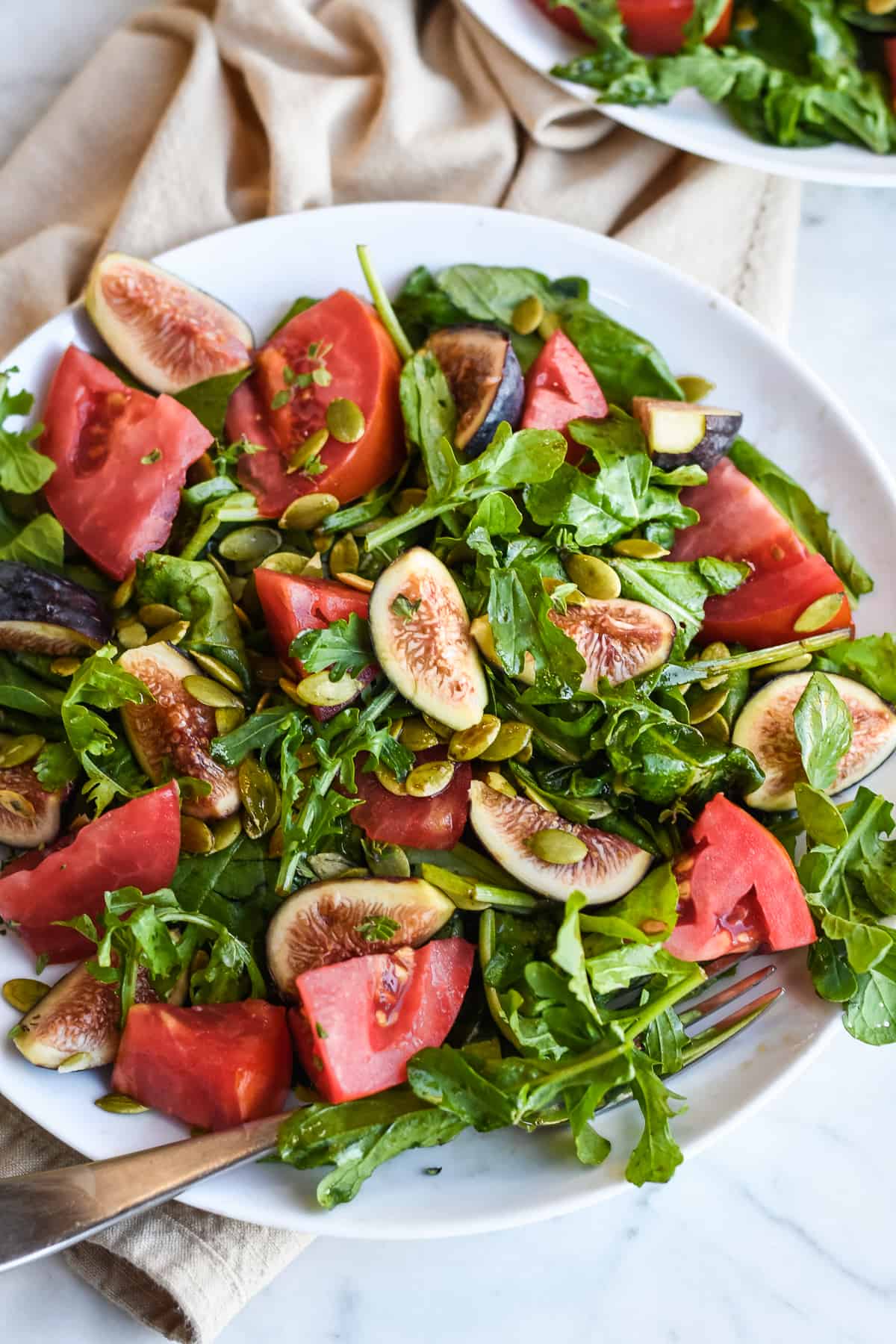 Fig Arugula Salad Tomato Salad on plate