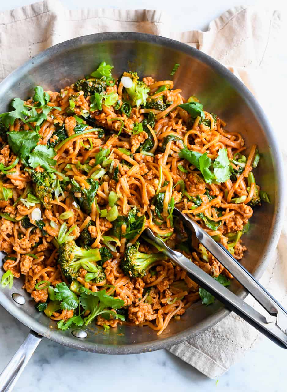 Easy Gochujang Noodles with Vegetables and Chicken in pan with tongs