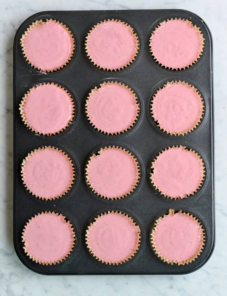 Strawberry layer of Mini Strawberry Cheesecakes in cupcake pan