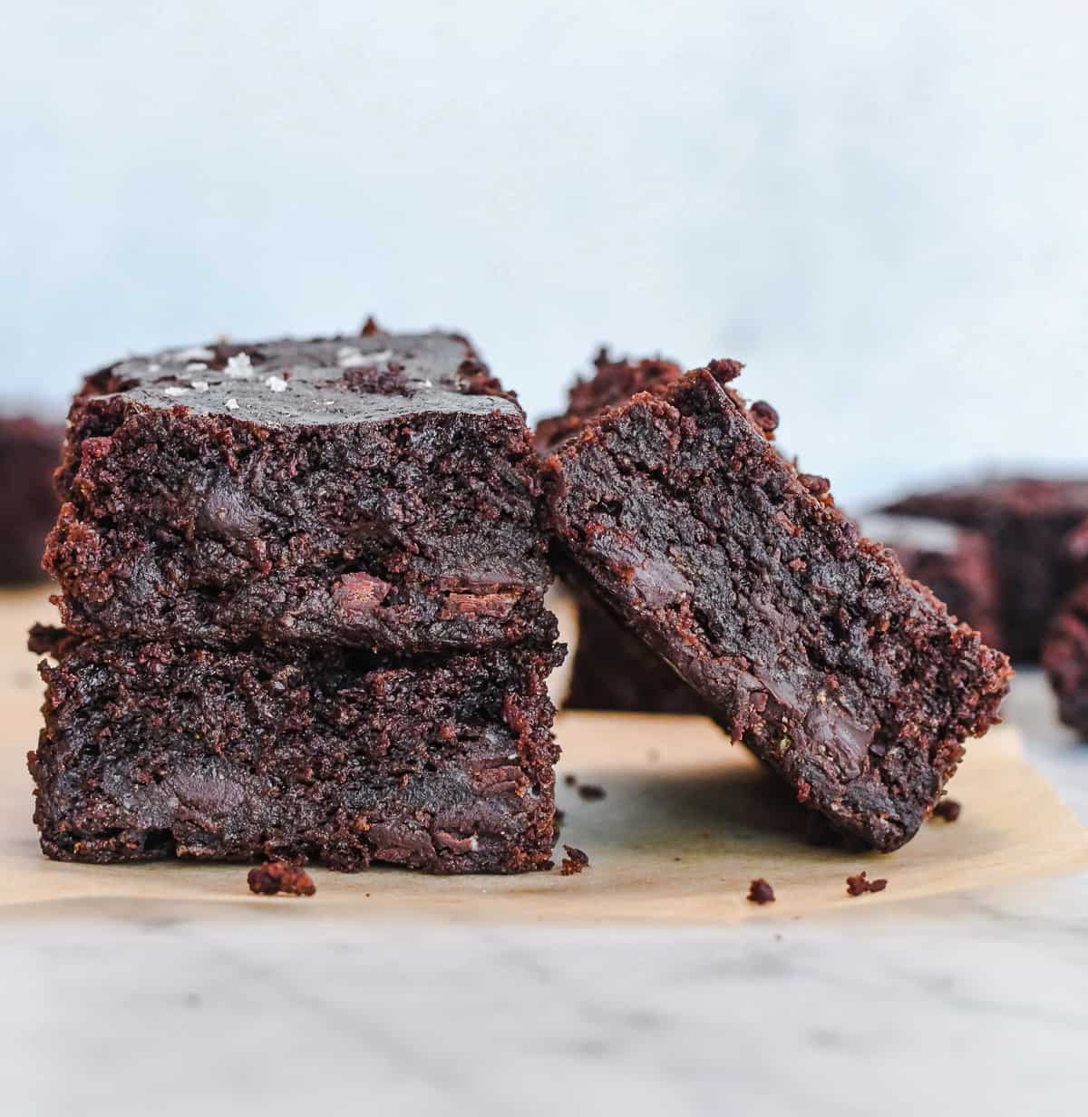 Healthy Zucchini Brownies Gluten Free 2 brownies stacked with on leaning