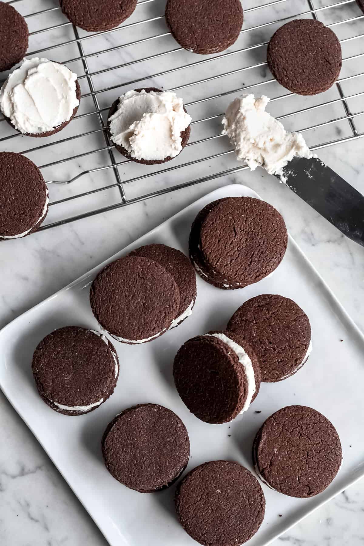 Healthy Homemade Oreos plate with cookies and spatula with filling