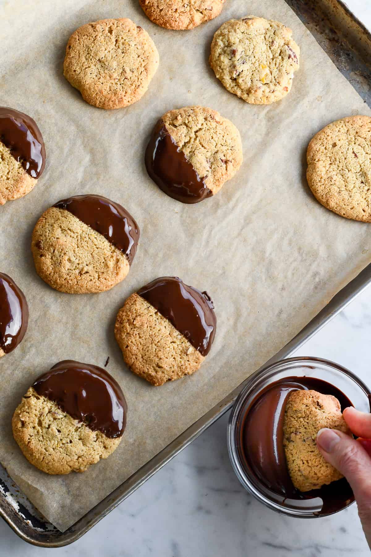 Maple Pecan Cookies with Chocolate Glaze dipping cookies in chocolate