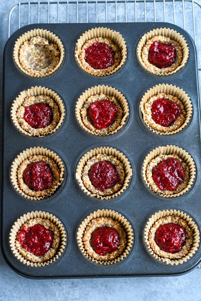 Raspberry Nut Cup Cookies muffing tin with crust and jam