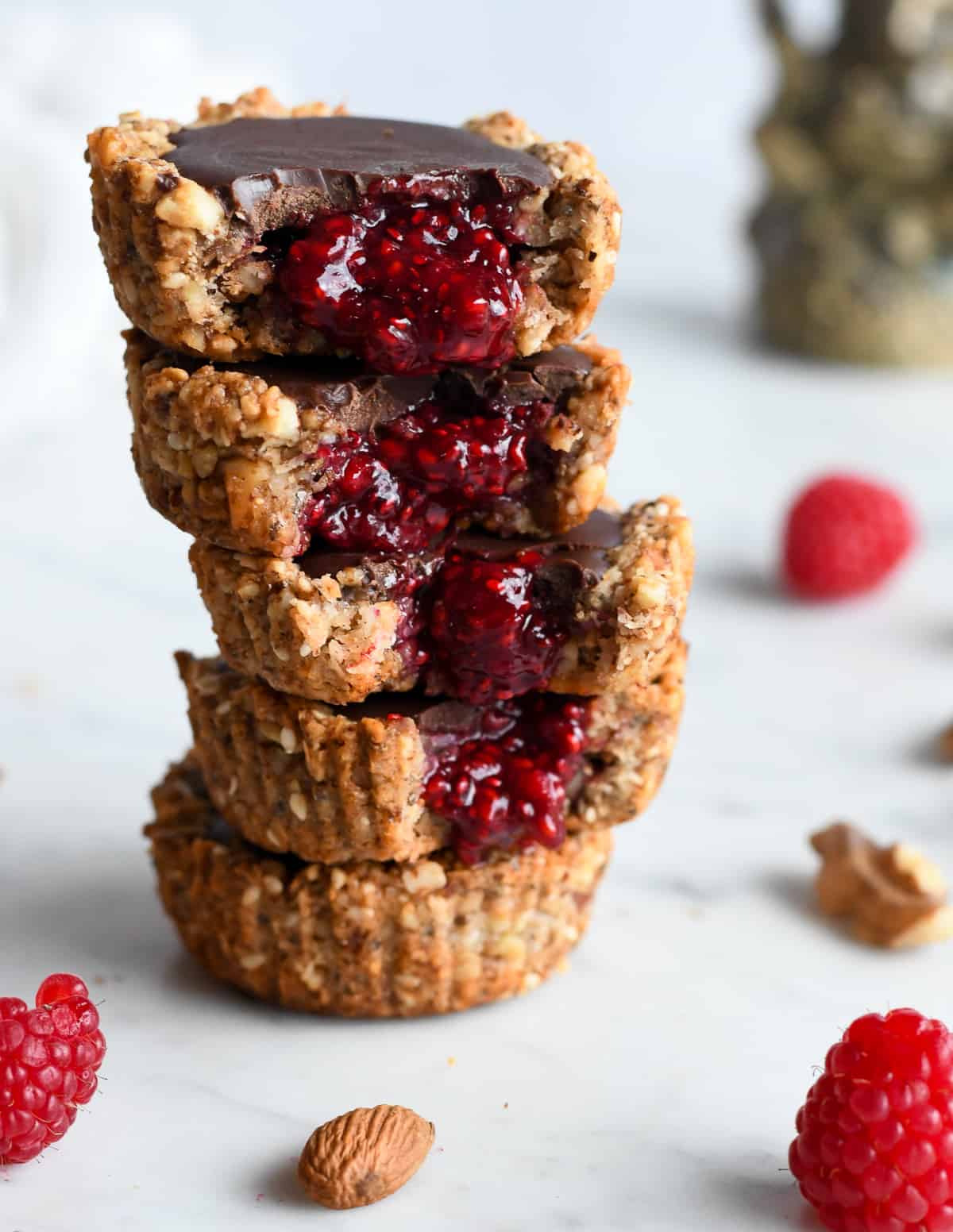 Raspberry Nut Cup Cookies stacked with raspberry chia jam showing