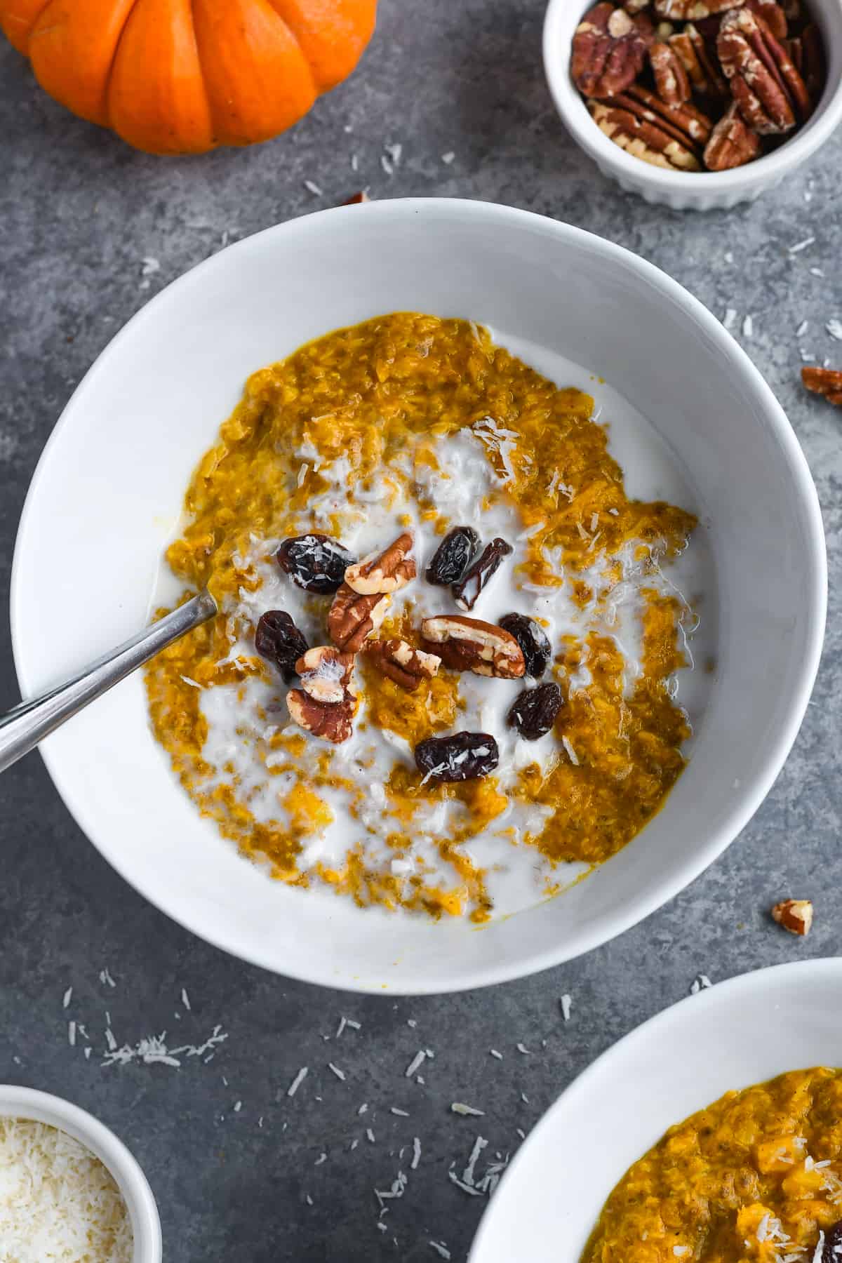 Anti-Inflammatory Paleo Pumpkin Porridge over view of bowl with pecans raisins and nut milk