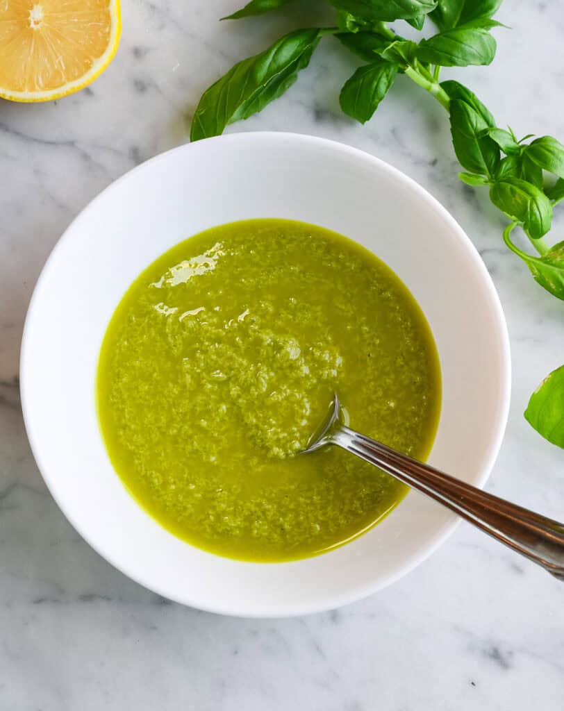 Lemon Basil Dressing in a bowl with a spoon