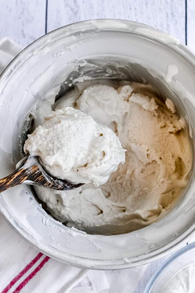 Paleo Ice Cream (Vegan) scooping out of ice cream maker with wooden spoon