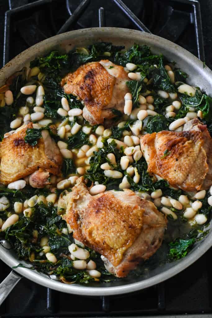 Braised Chicken with Kale, White Beans and Olives chicken kale and beans in pan