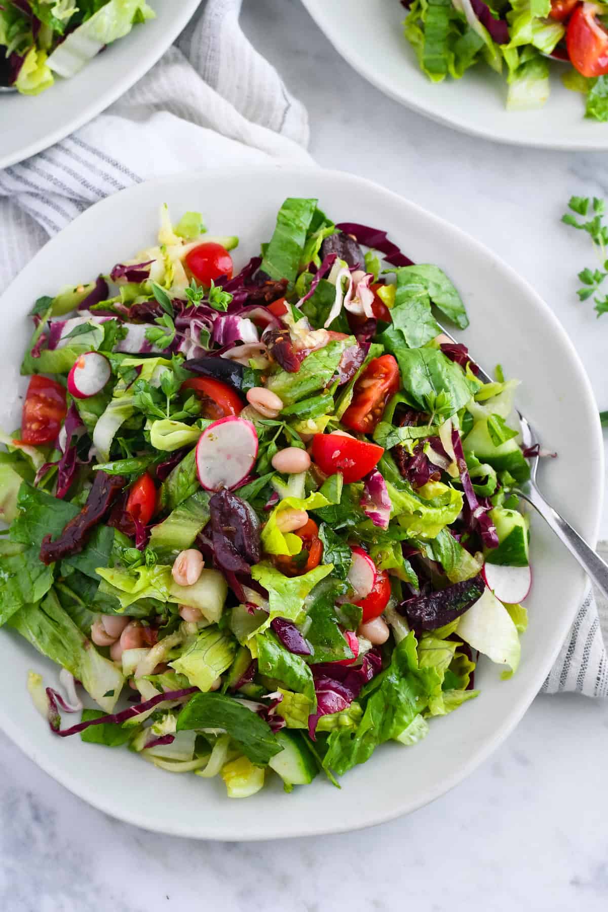 Mediterranean Chopped Salad on plate close up with fork and napkin