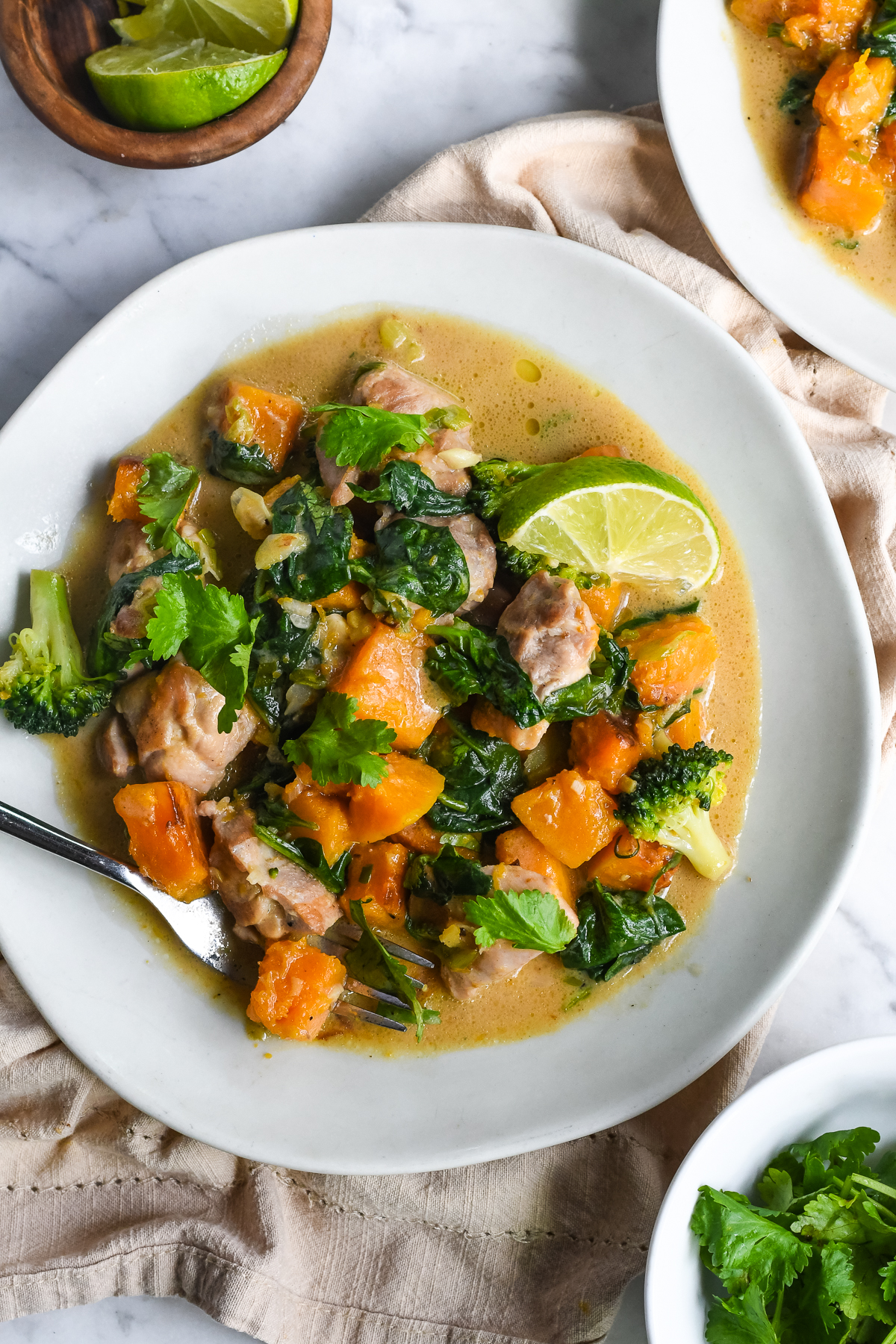 Ginger Coconut Chicken with Butternut Squash on a plate with fork