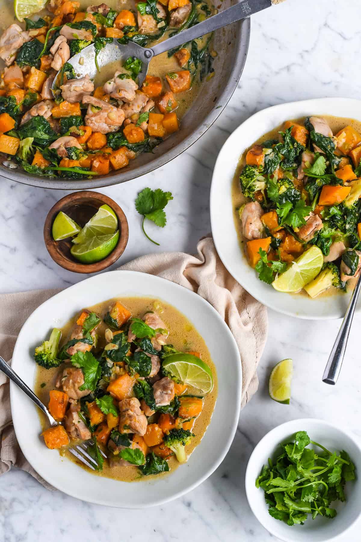 Ginger Coconut Chicken with Butternut Squash - pan and 2 plates with cilantro and lime on the side