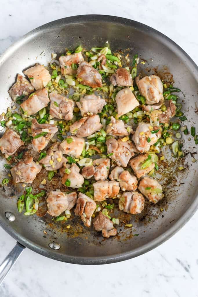 Ginger Coconut Chicken with Butternut Squash sautéing the chicken with scallions, garlic, ginger