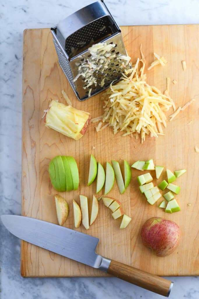 Healthy Apple Muffins grated and chopped apples on a wooden board