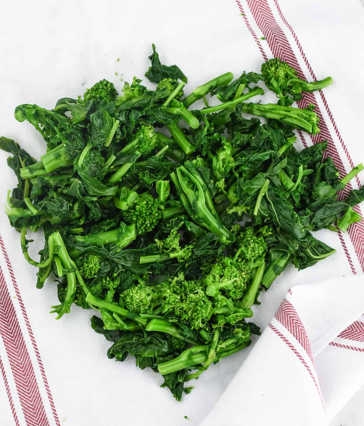 Sauteed Broccoli Rabe with Garlic and Olives drying blanched broccoli rabe on towel