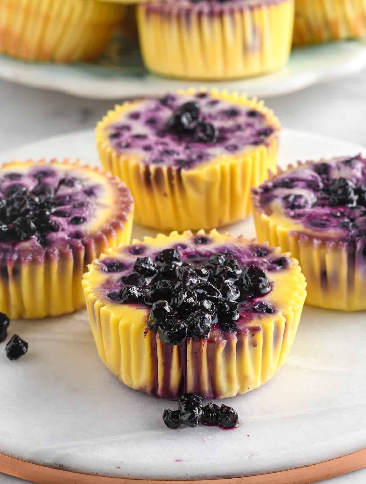 Easy Blueberry Cottage Cheese Bites close up with a little blueberry sauce on a pieces of marble