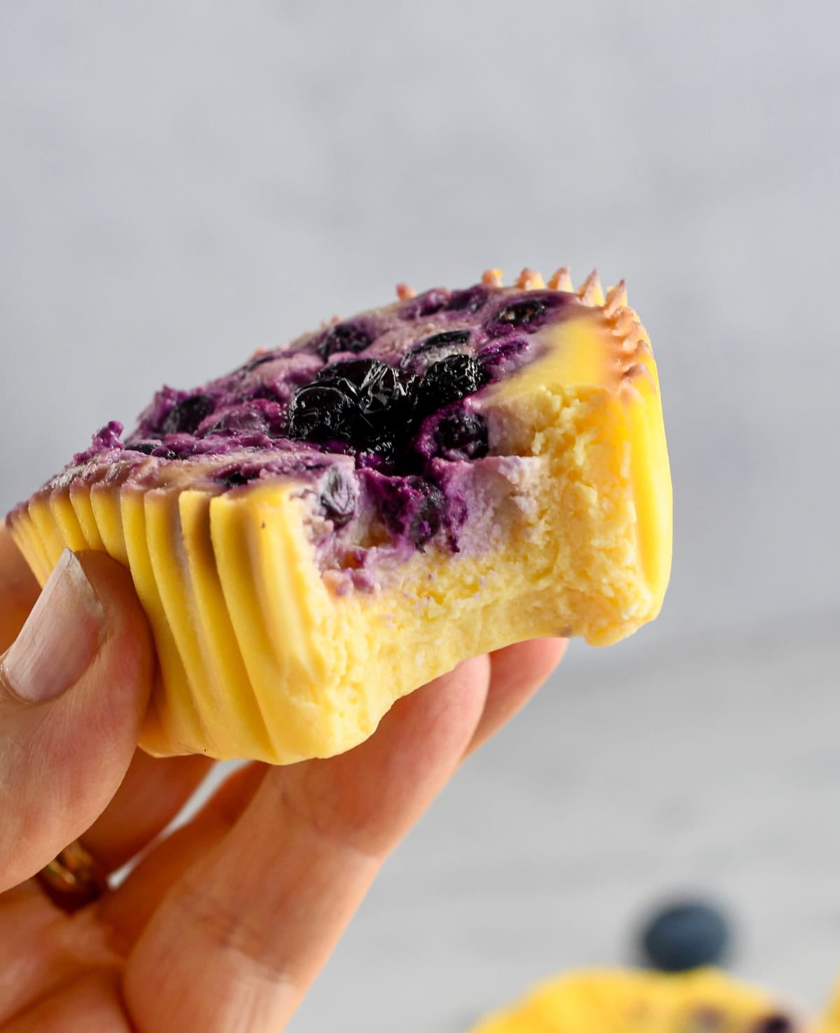 Easy Blueberry Cottage Cheese Bites in hand with a bite take out