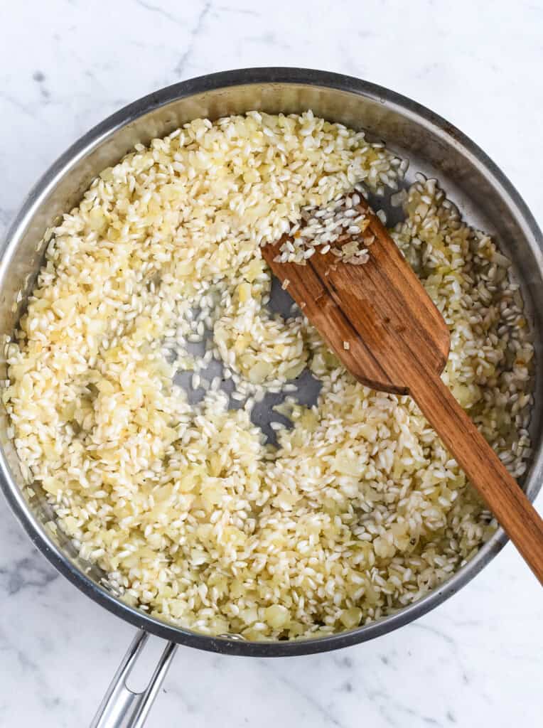 Saffron Risotto with Peas toasting rice and cooking wine