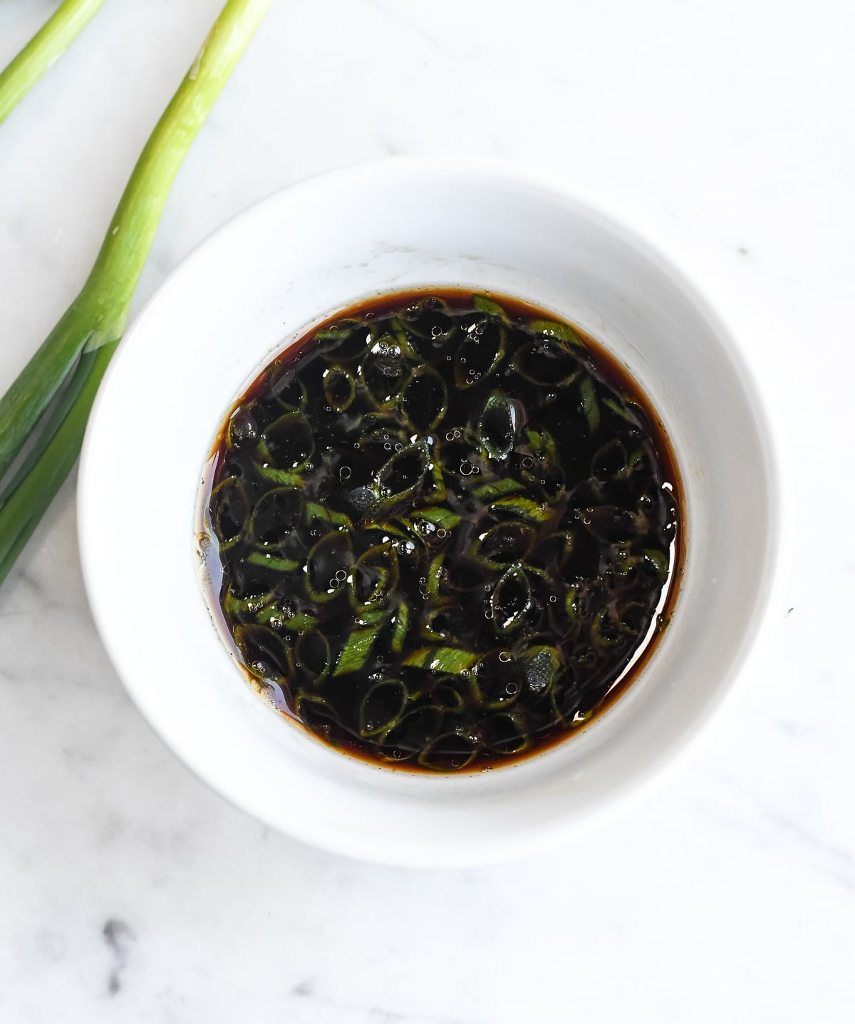 Asian Dipping Sauce in a bowl with scallions on the side
