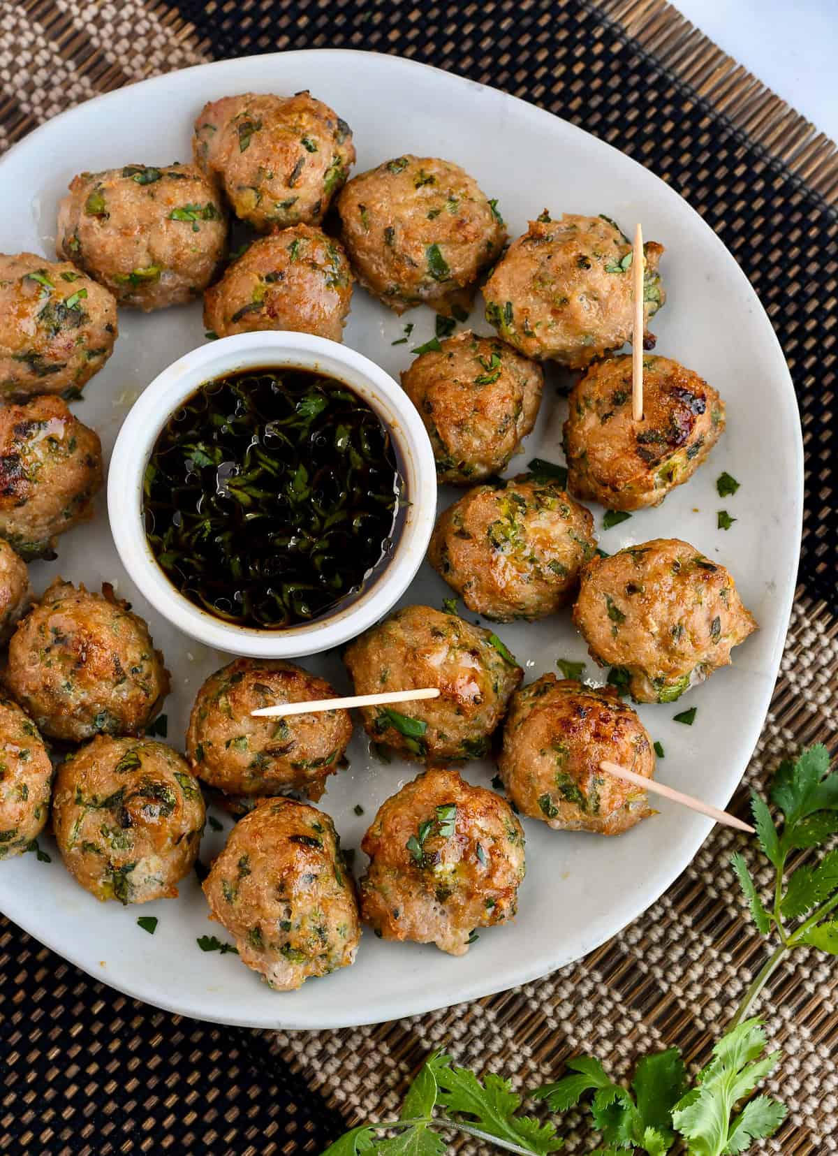 Asian Turkey Meatballs in a platter with toothpicks in 3 meatballs.