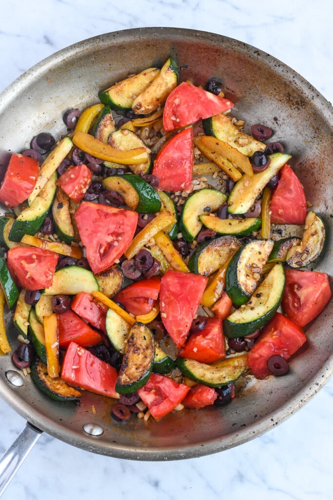 Mediterranean Shrimp Skillet with Vegetables tomatoes and olives added to skillet 