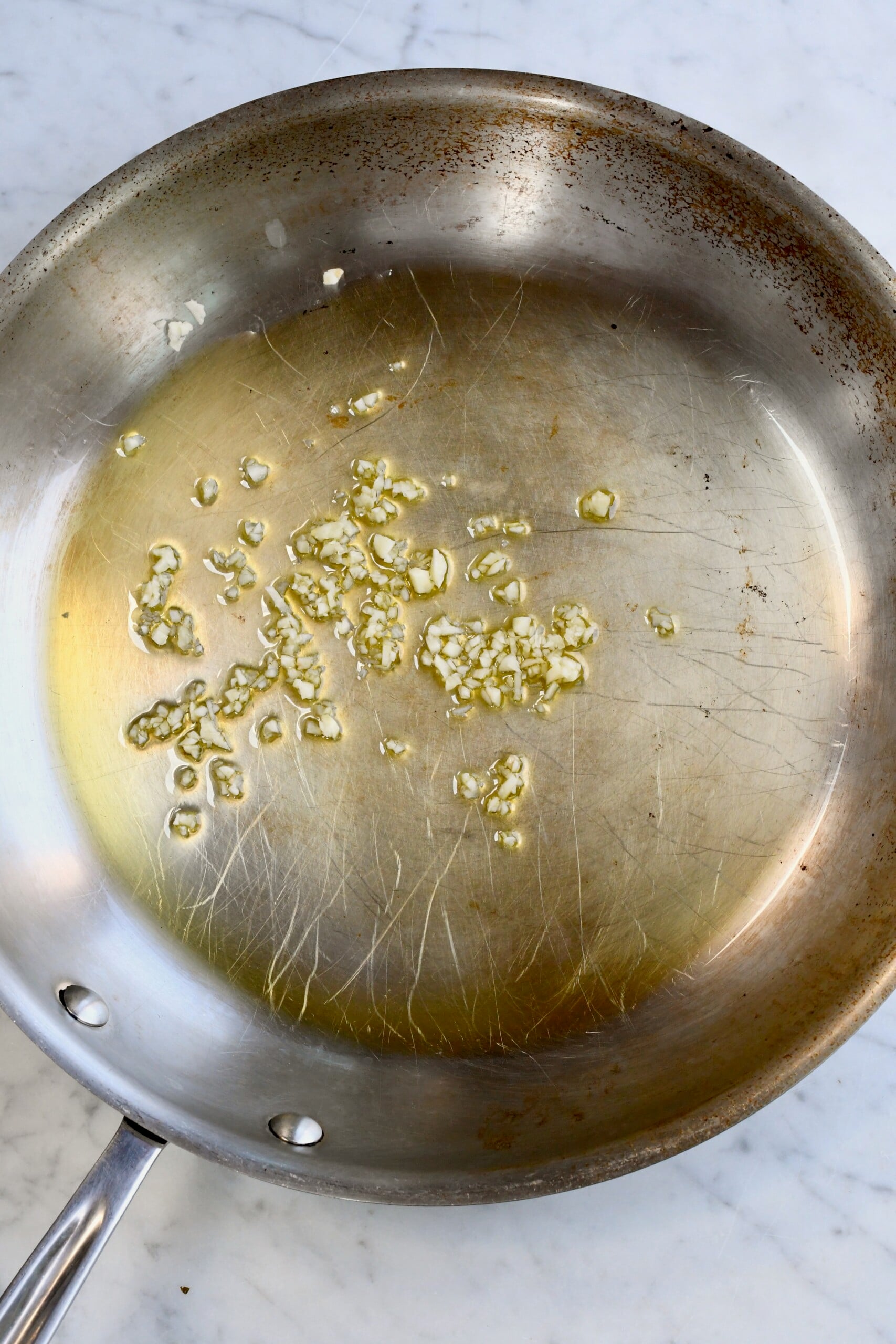 Easy Sautéed Romaine sauteing garlic in pan