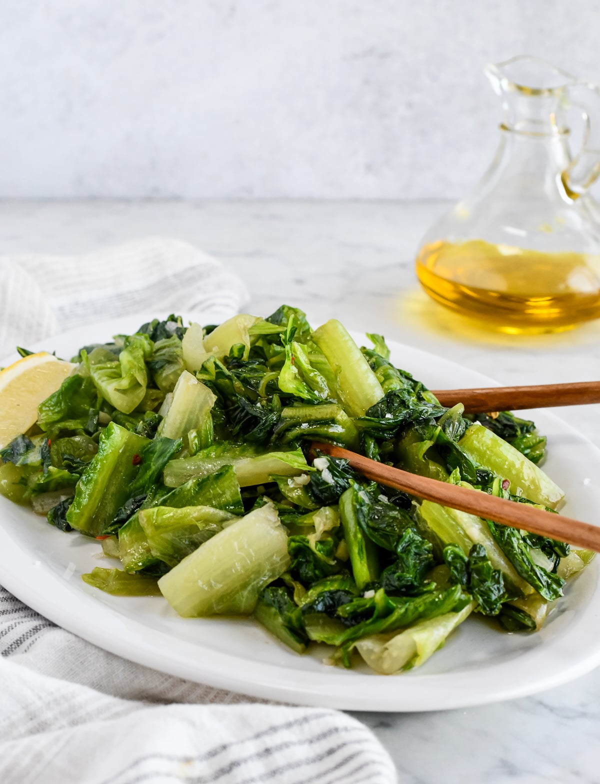 Easy Sautéed Romaine on serving platter with wooden serving spoons