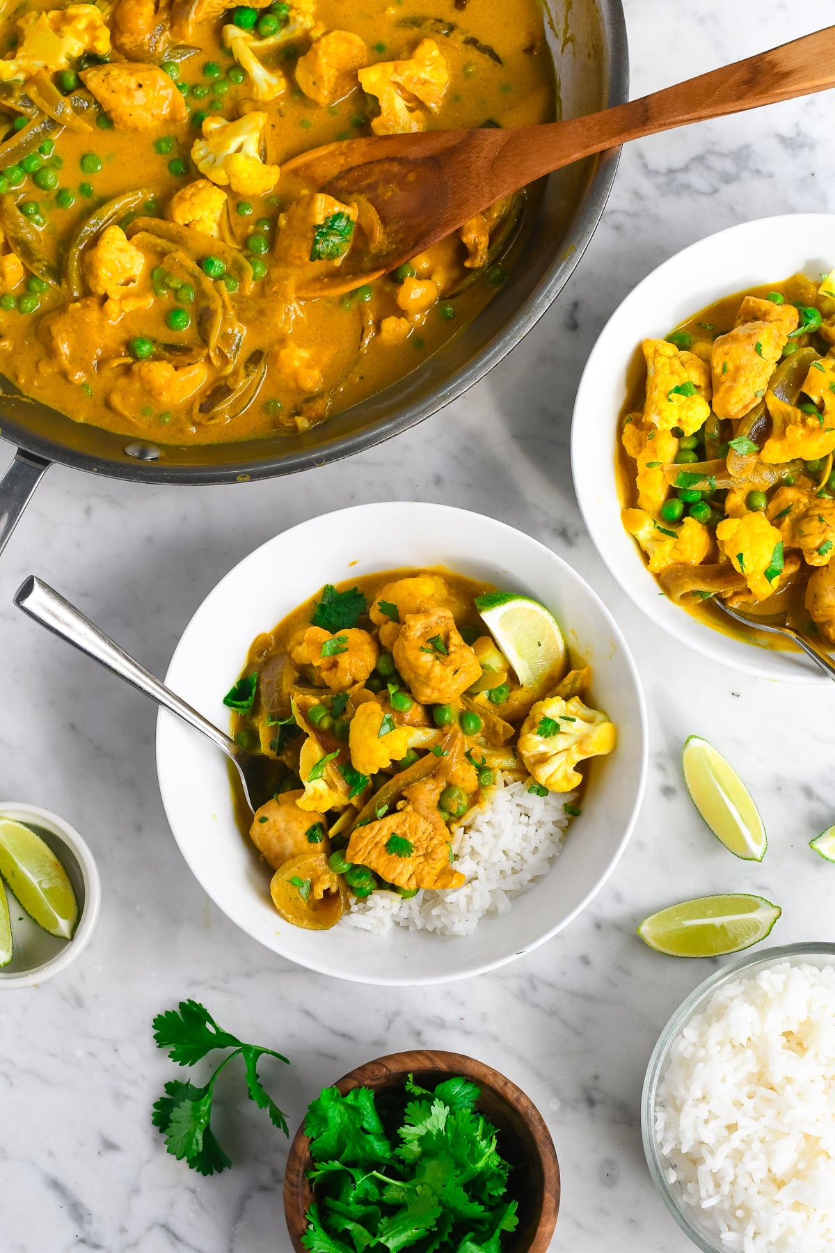 Creamy Pumpkin Curry with Coconut Milk 2 bowls and half the pan showing rice on the side